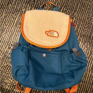 The North Face Blue and Orange Backpack with Classic Rucksack Design